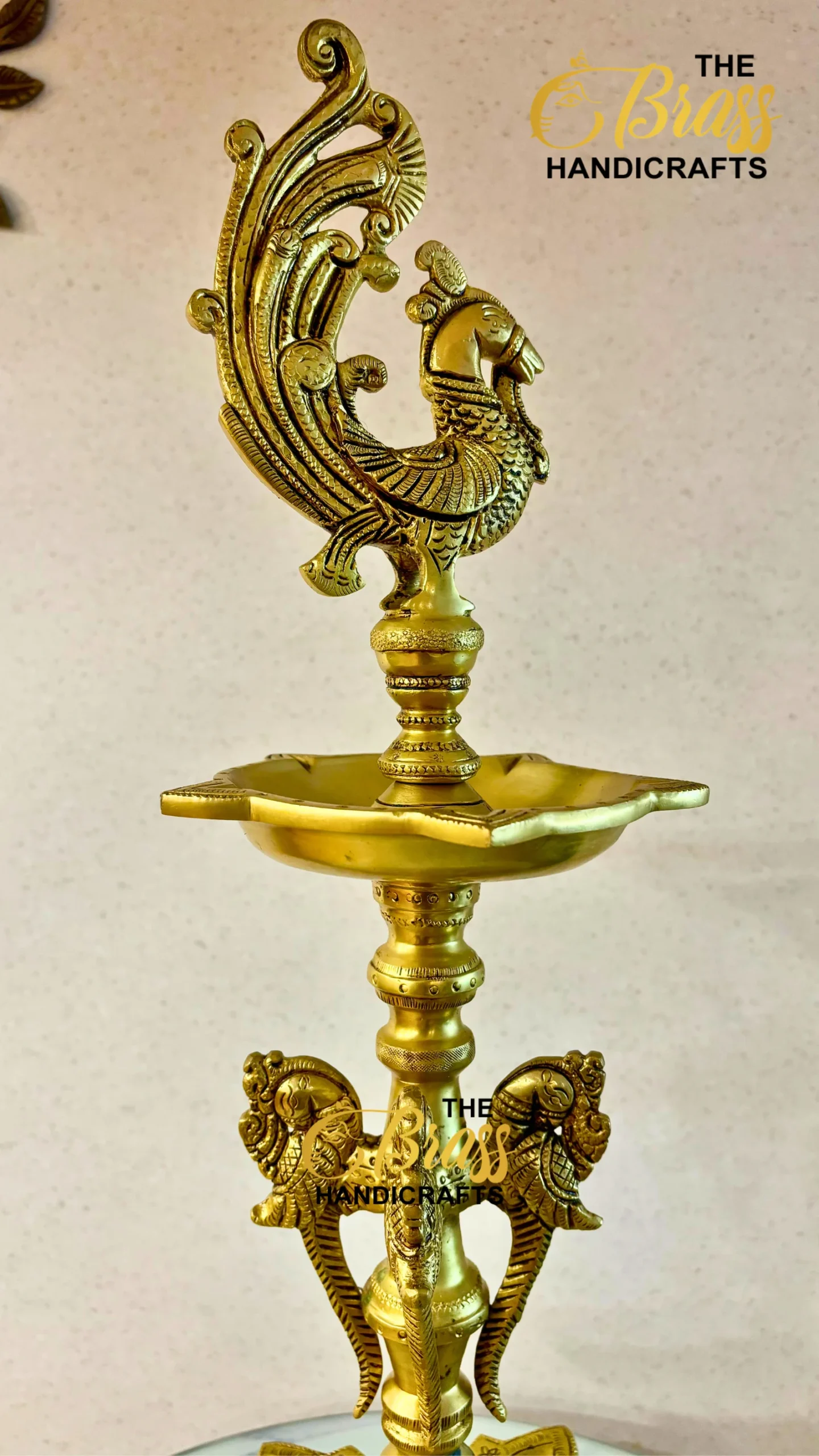 Ornate brass hookah with a peacock finial and decorative curved branches on a tray base  thebrasshandicrafts.com