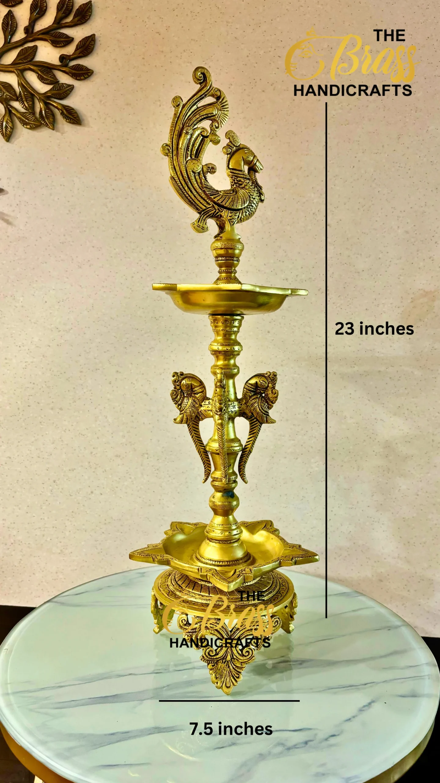 Ornate brass peacock finial atop a tall decorative pedestal, displayed on a marble surface, 23 inches tall with a 7.5 inch base.  thebrasshandicrafts.com