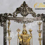 Ornate brass temple sculpture in a detailed frame with a central deity and hanging figures along the sides, featuring floral scrollwork.  thebrasshandicrafts.com