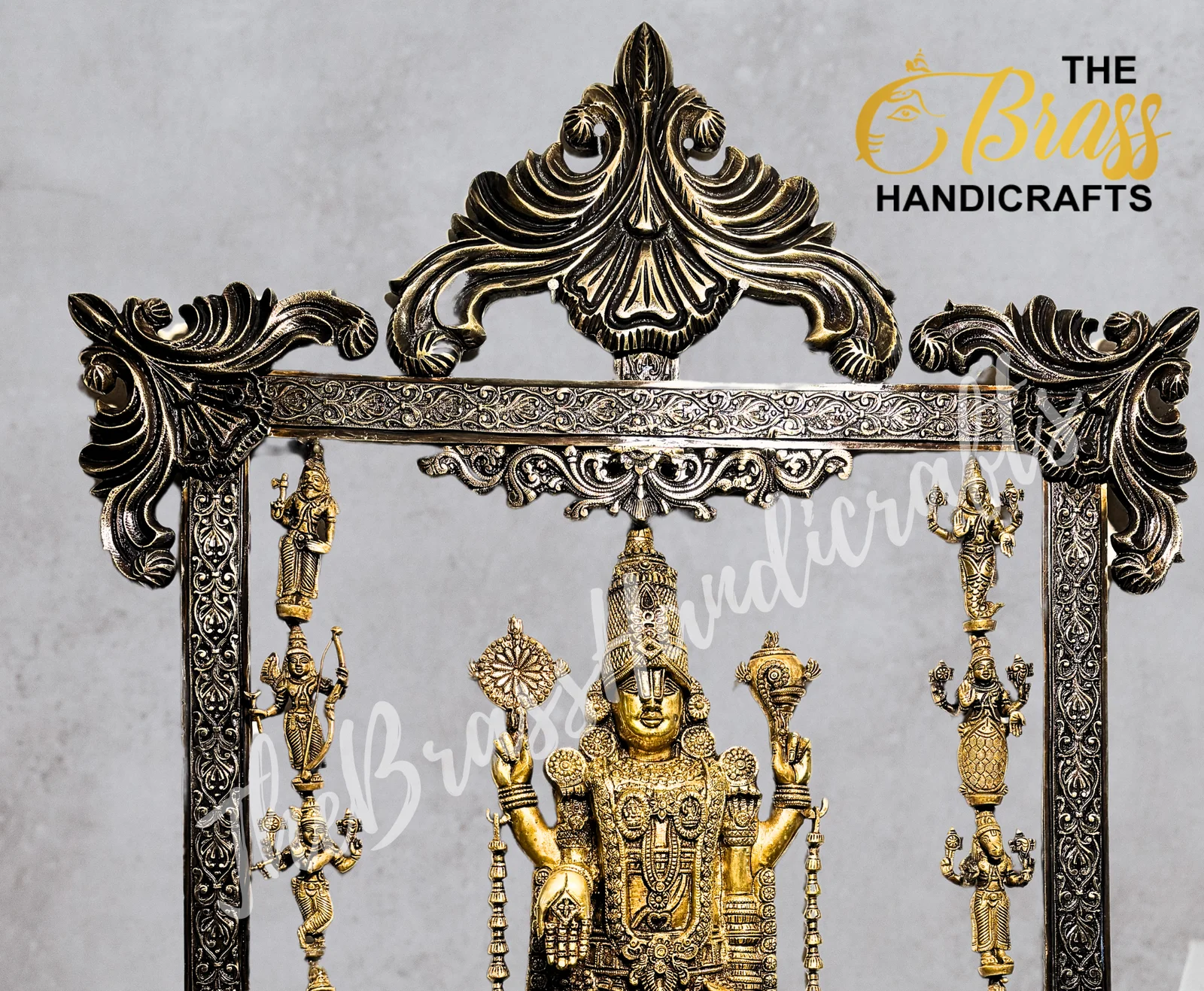Ornate brass temple sculpture in a detailed frame with a central deity and hanging figures along the sides, featuring floral scrollwork.  thebrasshandicrafts.com