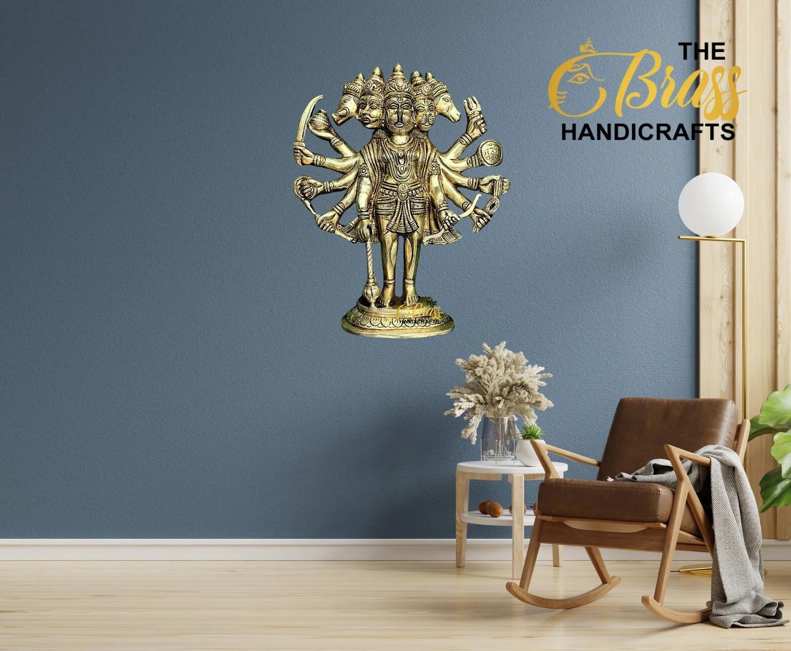 Ornate brass multi-armed deity statue mounted on a blue wall, with 'The Brass Handicrafts' logo in the corner and a rocking chair nearby.  thebrasshandicrafts.com
