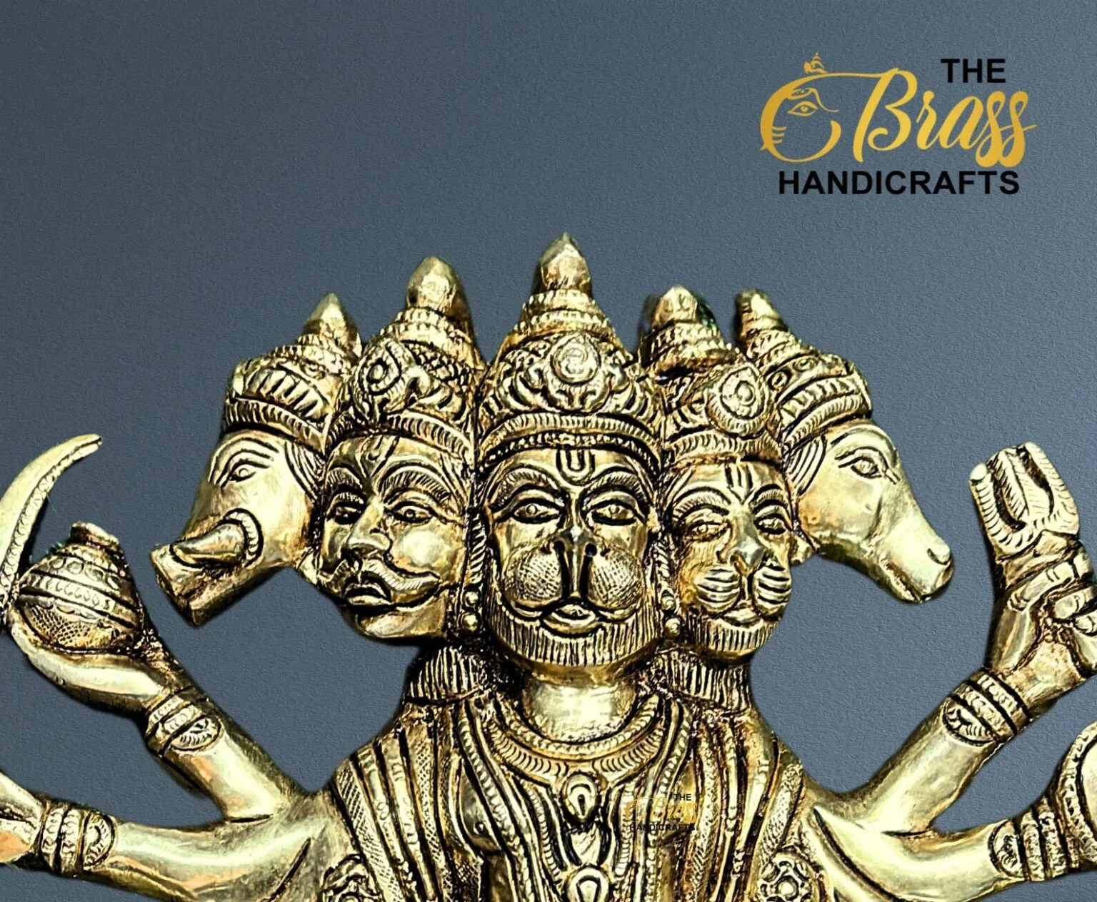Gold-toned brass statue of a multi-headed Hindu deity with many arms, set against a blue background; The Brass Handicrafts logo in the top-right corner.  thebrasshandicrafts.com