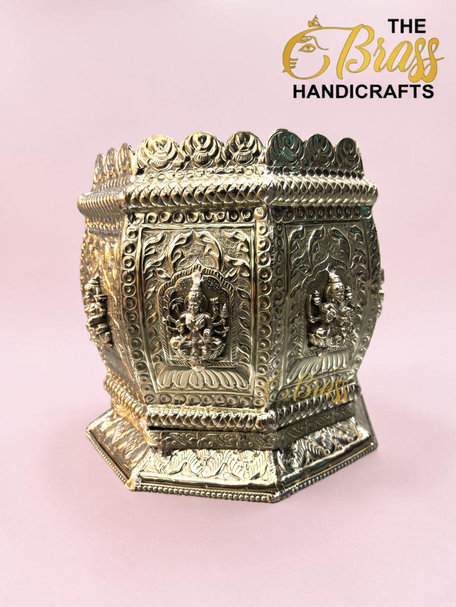 Ornate silver decorative box with embossed figures and floral patterns against a pink background.  thebrasshandicrafts.com