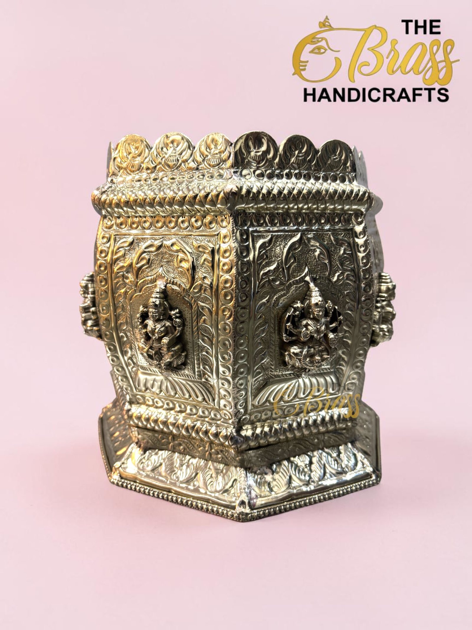 Ornate metal box with detailed embossed panels and beadwork, set against a pink background (decorative brass handicraft).  thebrasshandicrafts.com