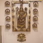 Ornate brass Hindu deity statue in a large decorative gold frame with smaller arch icons on the sides.  thebrasshandicrafts.com