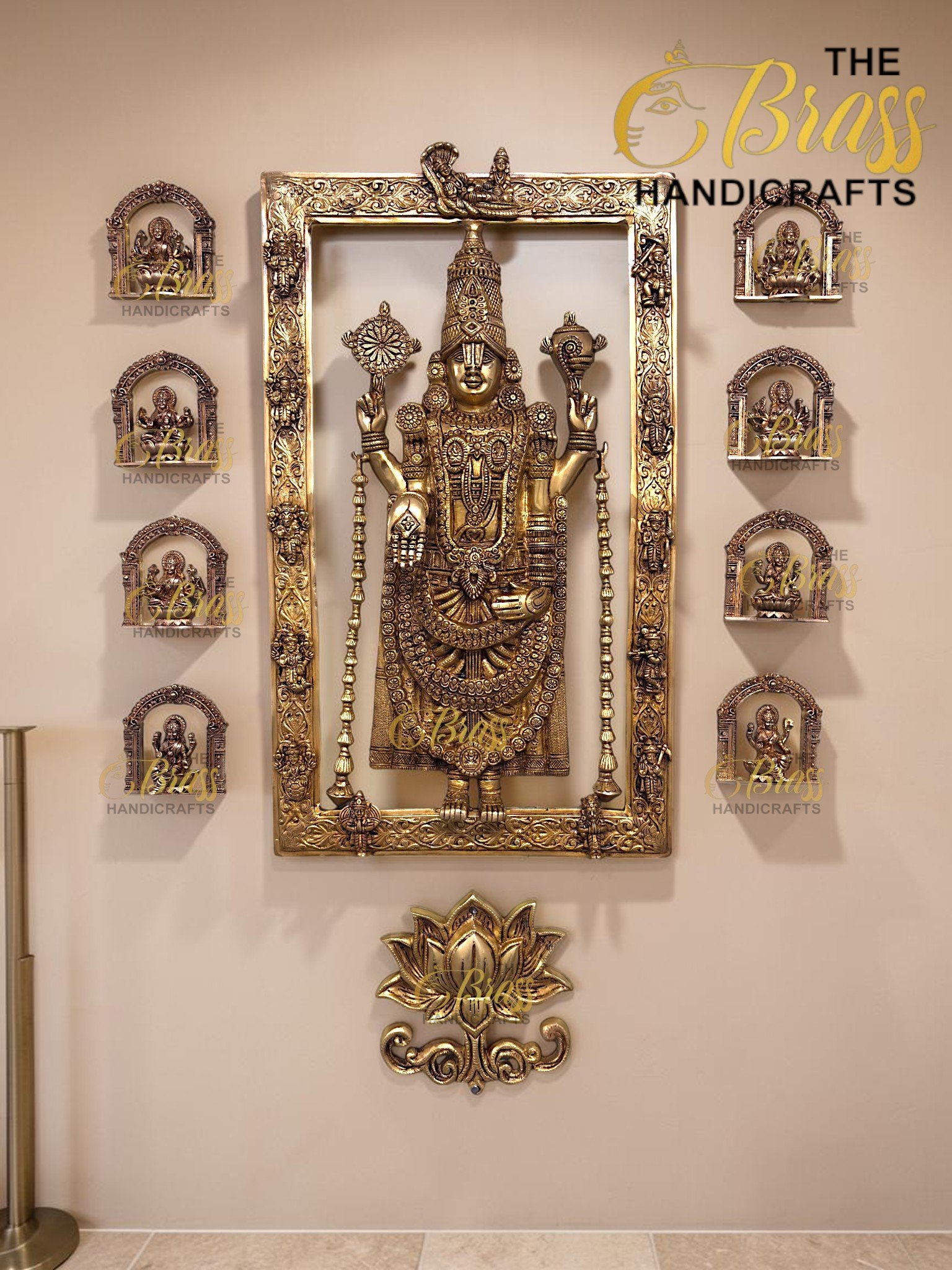 Ornate brass Hindu deity statue in a large decorative gold frame with smaller arch icons on the sides.  thebrasshandicrafts.com