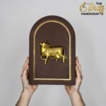 Brown plaque with a gold arched border and a gold horse relief, held by two hands against a gray background, brand visible in corner.  thebrasshandicrafts.com