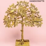 Gold metal tree sculpture with two birds perched on braided branches, set on a square base against a pink backdrop, branded The Brass Handicrafts in the corner.  thebrasshandicrafts.com