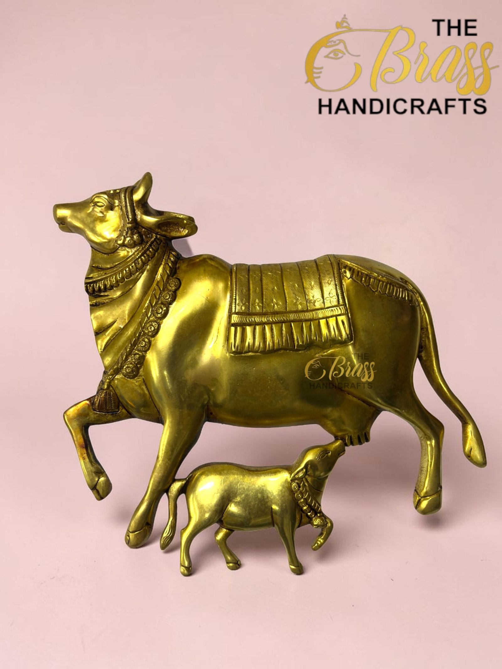 Gold brass statue of a standing horse with a foal beneath it on a pink background.  thebrasshandicrafts.com