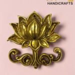 Gold decorative metal flower ornament on a pink background with a 'The Brass Handicrafts' logo in the corner.  thebrasshandicrafts.com