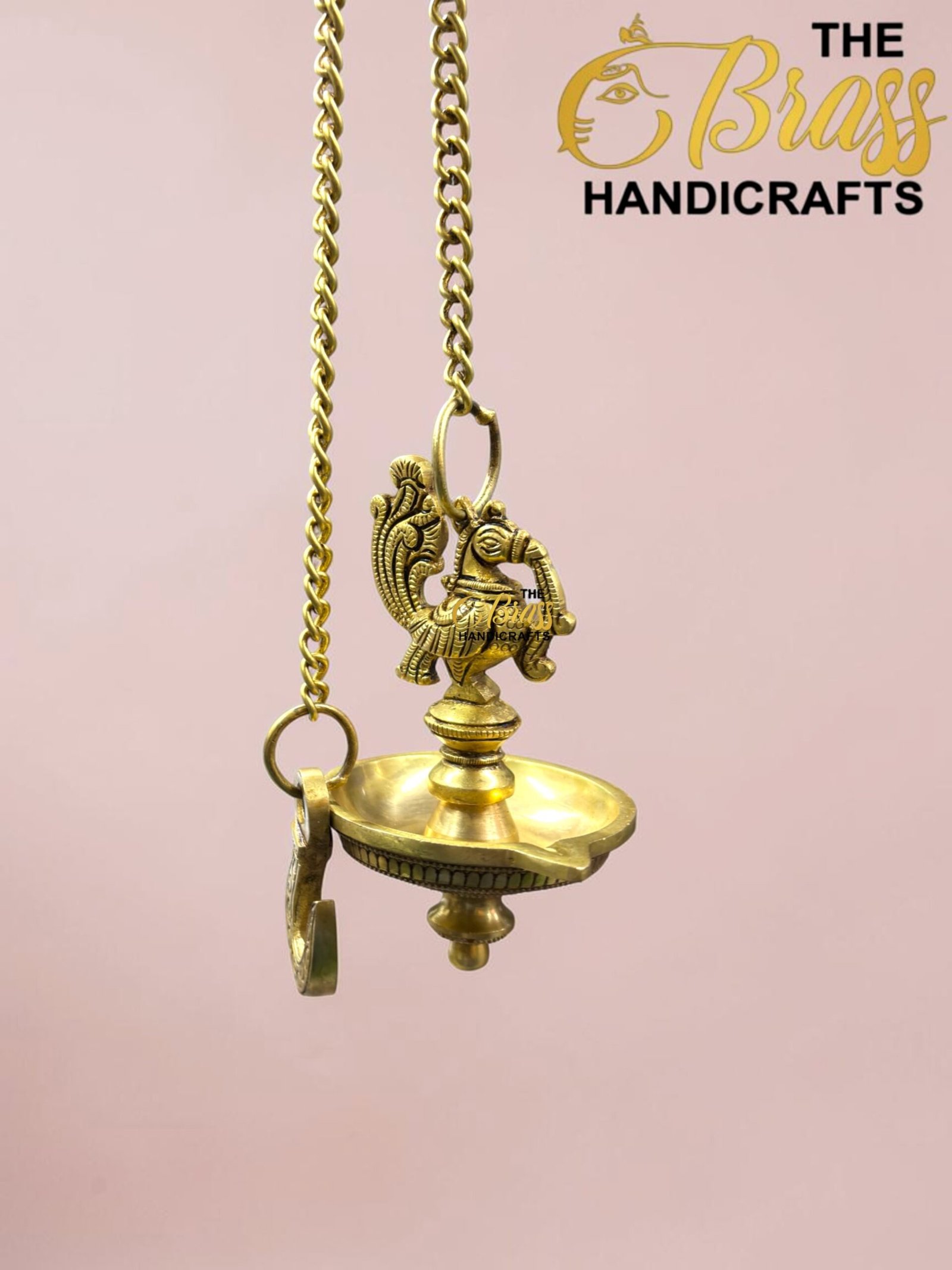 Close-up of an ornate brass hanging oil lamp suspended by a chain, showing intricate decorative detailing.  thebrasshandicrafts.com