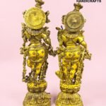 IMG_5927 - thebrasshandicrafts.com Two ornate gold horse statues with round shield-like backs on a pink background, showcasing intricate detailing. thebrasshandicrafts.com