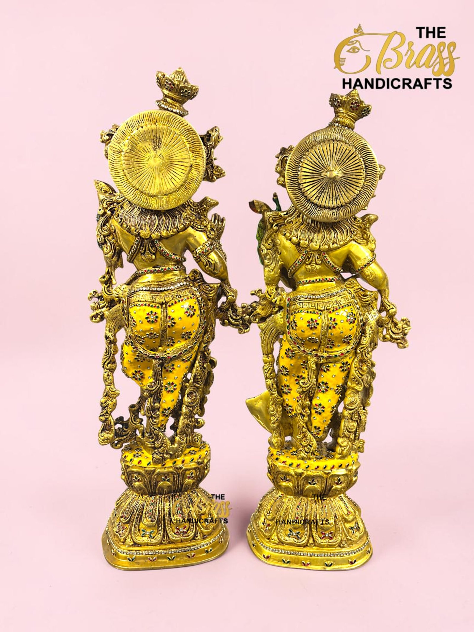 IMG_5927 - thebrasshandicrafts.com Two ornate gold horse statues with round shield-like backs on a pink background, showcasing intricate detailing. thebrasshandicrafts.com