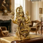 il_1588xN7655146345_4koo - thebrasshandicrafts.com Gold ornate Hindu deity statue with multiple arms on a piano in a luxurious living room, chandelier and classical decor in background. thebrasshandicrafts.com