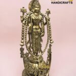 Golden ornate Hindu deity statue adorned with long bead garlands, pink background.  thebrasshandicrafts.com