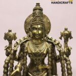 Gold brass statue of a multi-armed Hindu goddess with an ornate headdress, intricate jewelry, and ceremonial symbols, on a pale pink background. (Brand: The Brass Handicrafts)  thebrasshandicrafts.com