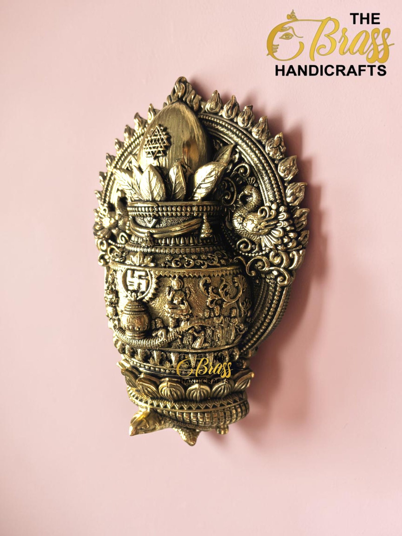 IMG_6158 - thebrasshandicrafts.com Decorative brass sculpture with intricate patterns and crown, set against a pink wall. thebrasshandicrafts.com