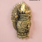 IMG_6159 - thebrasshandicrafts.com Intricately detailed gold-brass decorative piece with floral motifs, mounted on a pink wall thebrasshandicrafts.com
