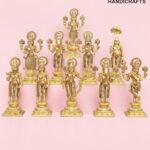 Row of gold brass Hindu deity statues arranged on a pink background with a logo in the corner: 'The Brass Handicrafts'  thebrasshandicrafts.com
