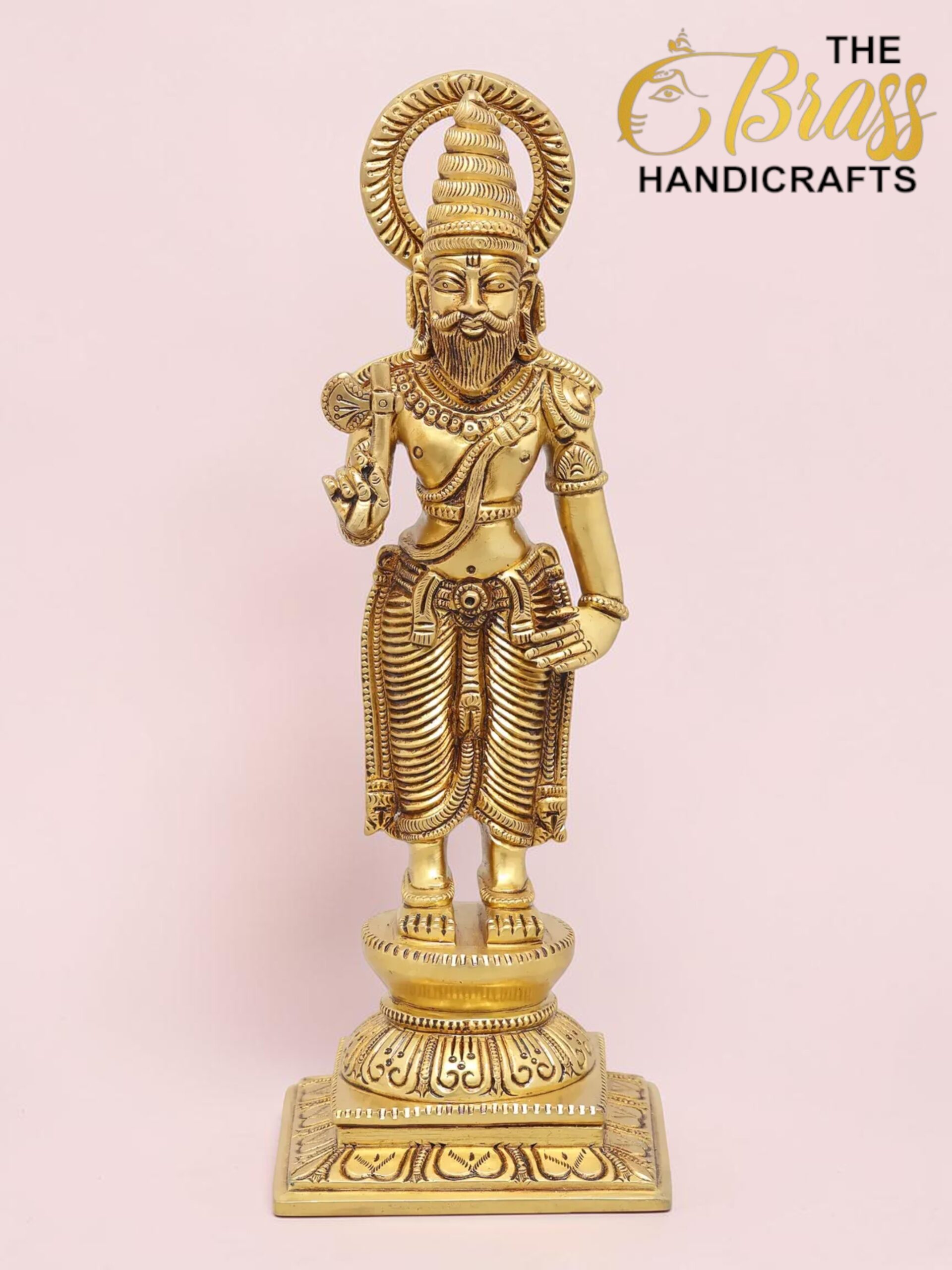 Gold-toned brass statue of a Hindu sage with a tall headdress and halo, standing on an ornate pedestal.  thebrasshandicrafts.com