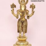 Gold-colored brass statue of Hindu god Ganesha with a halo, standing on an ornate pedestal.  thebrasshandicrafts.com