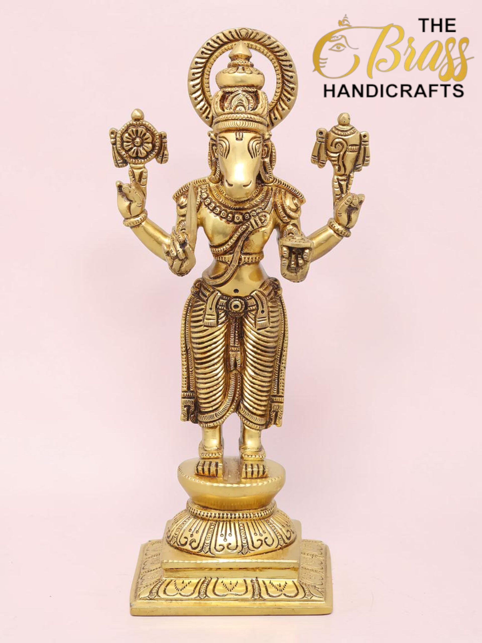 Gold-colored brass statue of Hindu god Ganesha with a halo, standing on an ornate pedestal.  thebrasshandicrafts.com