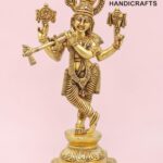 Gold-toned brass Hindu deity statue with multiple arms, ornate jewelry, standing on a pedestal against a pink background; logo 'The Brass Handicrafts' in corner.  thebrasshandicrafts.com