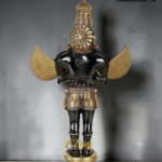 Bronze statue of a Hindu deity with an ornate crown and gold wings, standing on a patterned pedestal.  thebrasshandicrafts.com