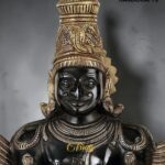 Black and gold statue of the Hindu deity Ganesha with an ornate headdress and detailed jewelry, logo 'The Brass Handicrafts' visible in corner  thebrasshandicrafts.com