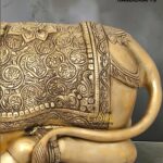 nandi 5 - thebrasshandicrafts.com Gold-toned elephant statue with intricate embossed designs and a patterned saddle, watermark 'The Brass Handicrafts' visible in the corner thebrasshandicrafts.com