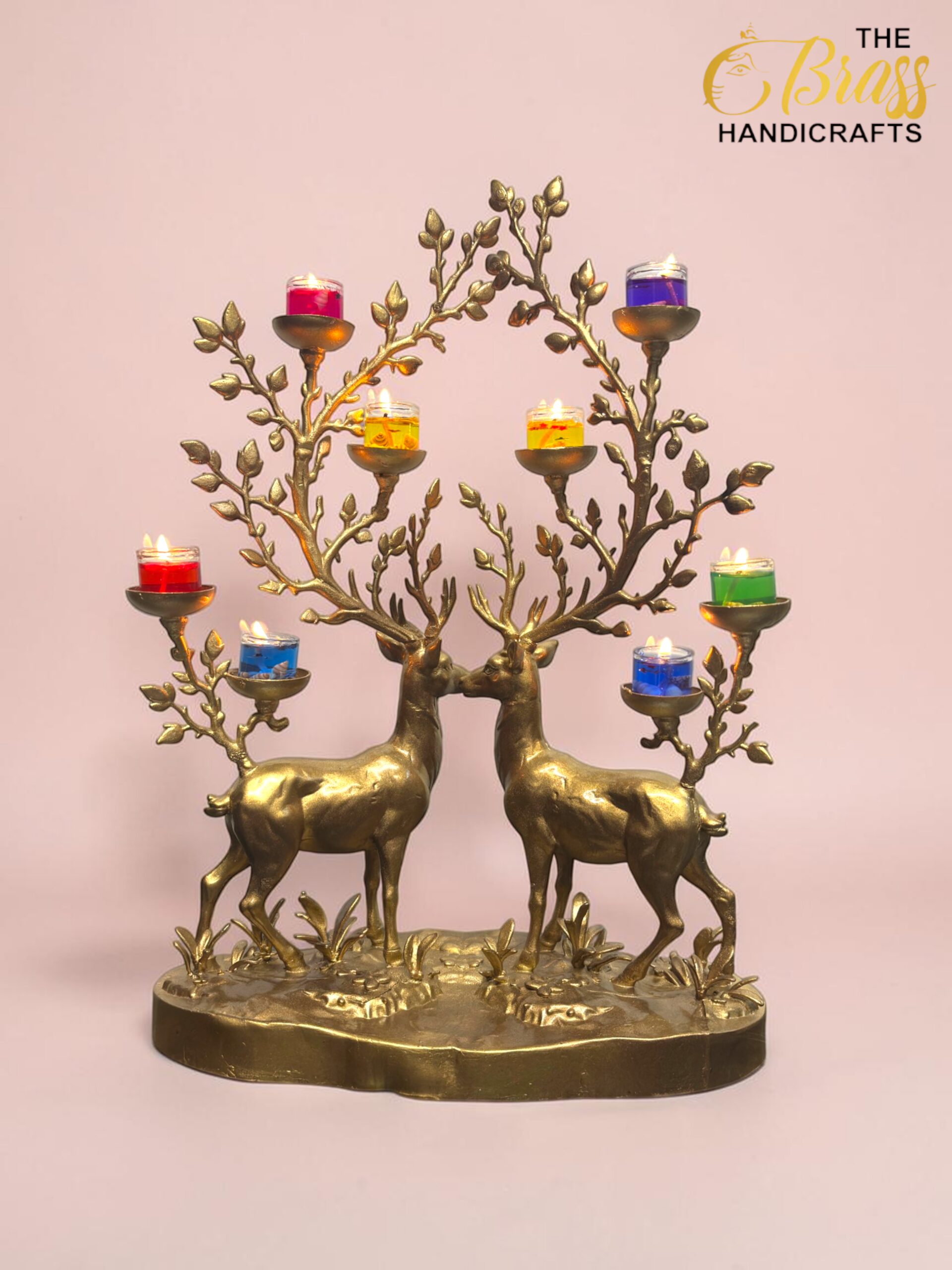 Ornate brass candelabra shaped by two deer whose branches hold multicolored tea candles in glass cups.  thebrasshandicrafts.com