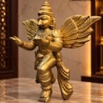 Golden Garuda Statue in Warm Temple Light - thebrasshandicrafts.com Gold statue of a winged mythological figure with outstretched arms on a marble countertop. thebrasshandicrafts.com
