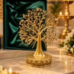 Golden Tree of Life in Festive Elegance 1 - thebrasshandicrafts.com Gold-tone tree sculpture with intricate branches on a decorative pedestal, displayed on a marble altar with a green velvet-lined box in the background thebrasshandicrafts.com