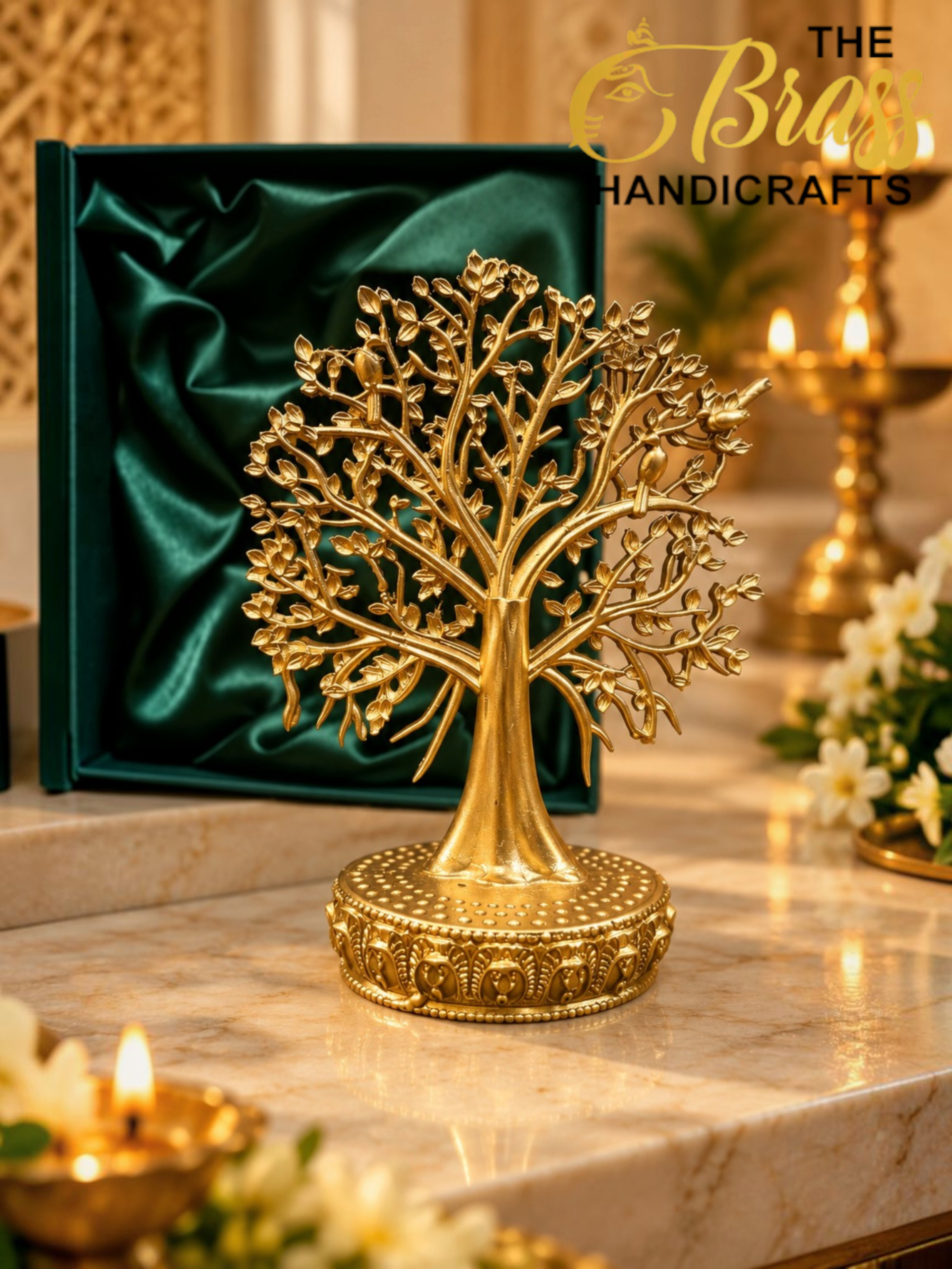 Golden Tree of Life in Festive Elegance 1 - thebrasshandicrafts.com Gold-tone tree sculpture with intricate branches on a decorative pedestal, displayed on a marble altar with a green velvet-lined box in the background thebrasshandicrafts.com