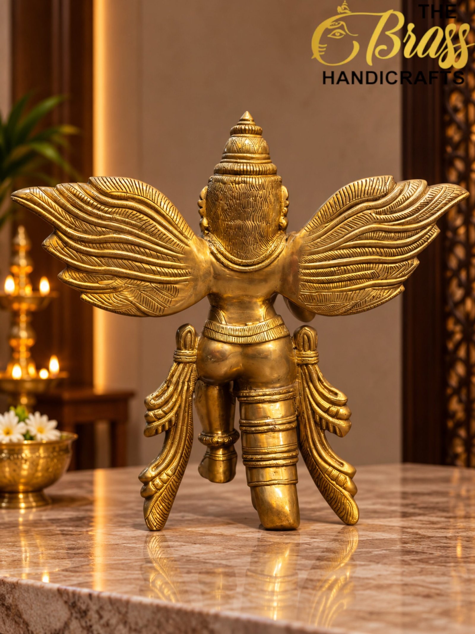Golden Winged Deity Statue in Warm Altar Light - thebrasshandicrafts.com Golden ceremonial statue with large, detailed wings on a marble surface, softly lit interior in the background. thebrasshandicrafts.com