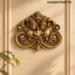 Ornate gold brass decorative crest mounted on a beige wall with a frame; 'The Brass Handicrafts' logo in the upper right corner.  thebrasshandicrafts.com