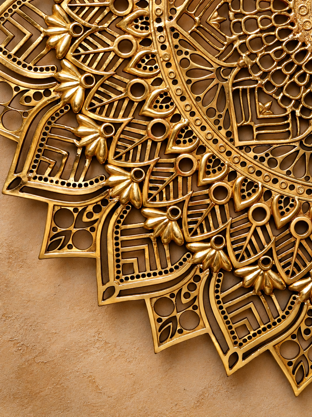 d5a16118-ef9d-4de3-aea6-55d7be94fb98 - thebrasshandicrafts.com Close-up of an intricate gold filigree pattern with floral motifs on a warm beige background, conveying luxury and craftsmanship. thebrasshandicrafts.com