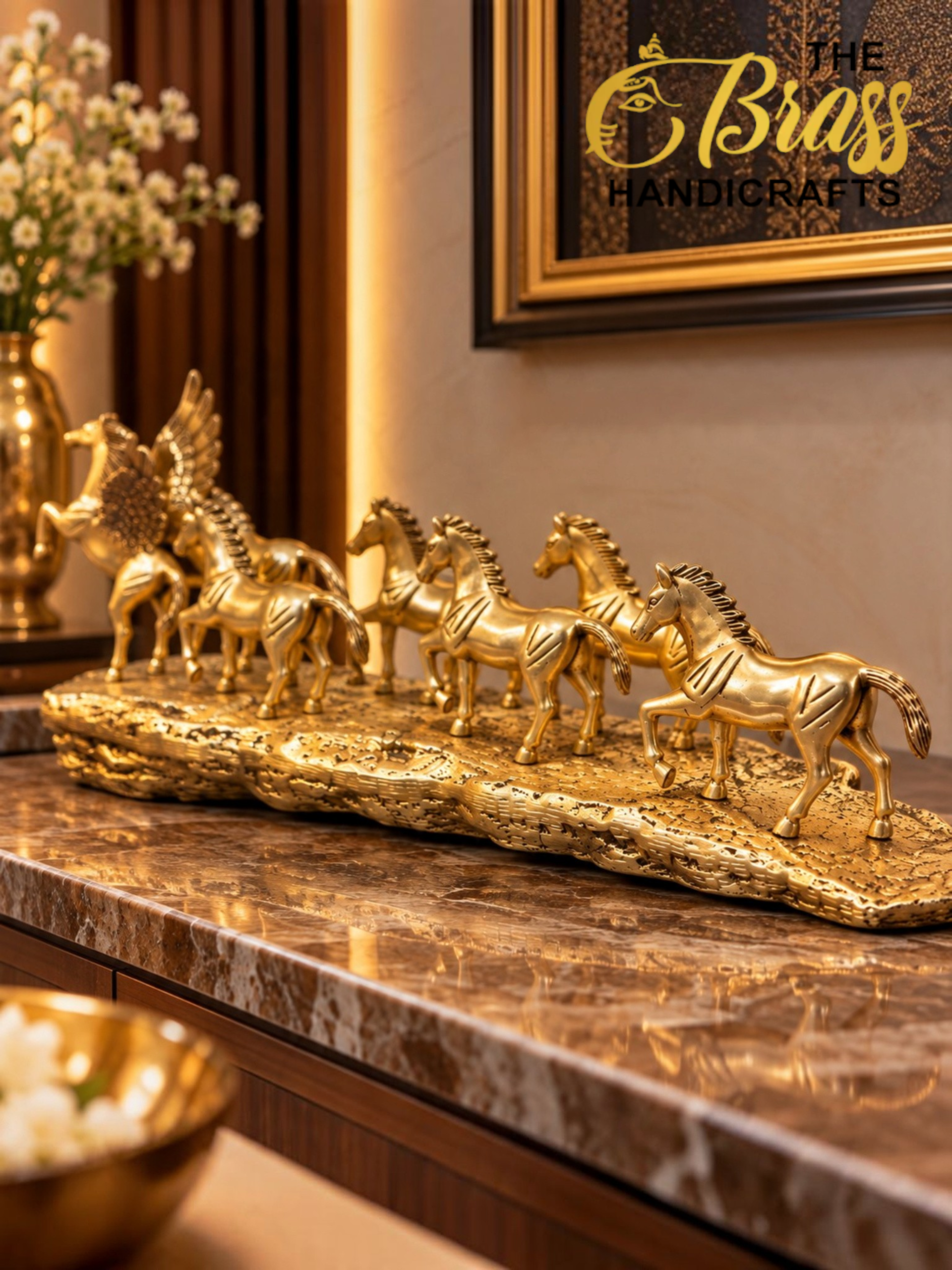 horses 3 - thebrasshandicrafts.com Row of golden horse statues arranged along a marble countertop with a framed artwork in the background. thebrasshandicrafts.com