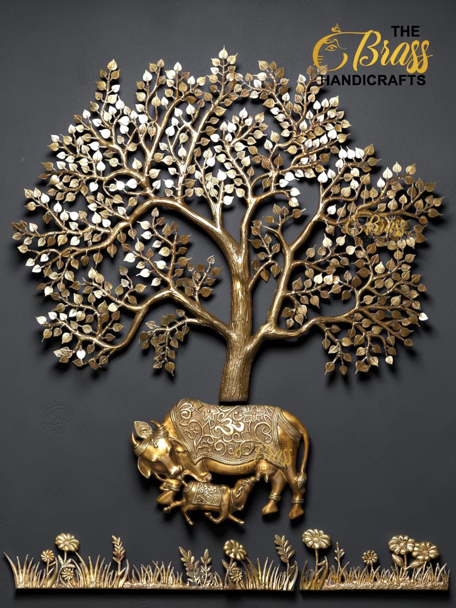 Decorative gold tree sculpture growing from a gold elephant on a dark wall background.”],  thebrasshandicrafts.com
