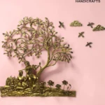il_1588xN8398831888_msui - thebrasshandicrafts.com Gold brass tree sculpture with carved figures at its base on a pink background, with The Brass Handicrafts branding nearby. thebrasshandicrafts.com